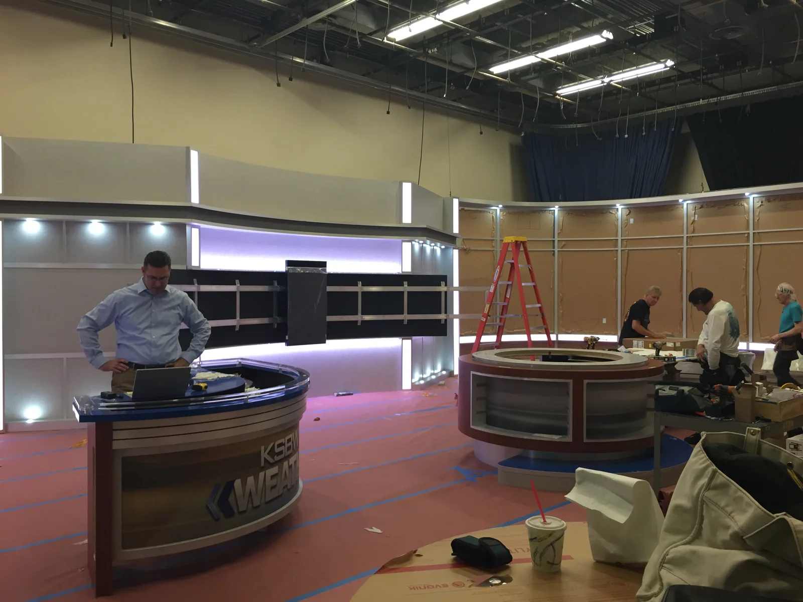 Desk and scenic assembly across the studio floor