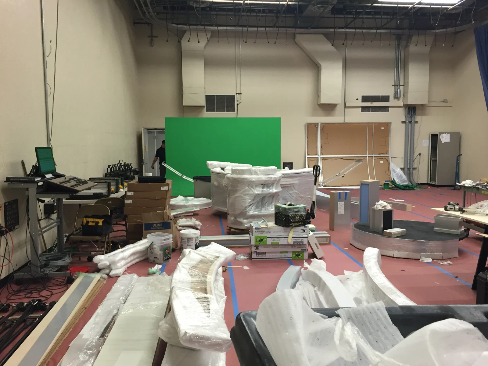 Scenic components staged beside the green-screen area
