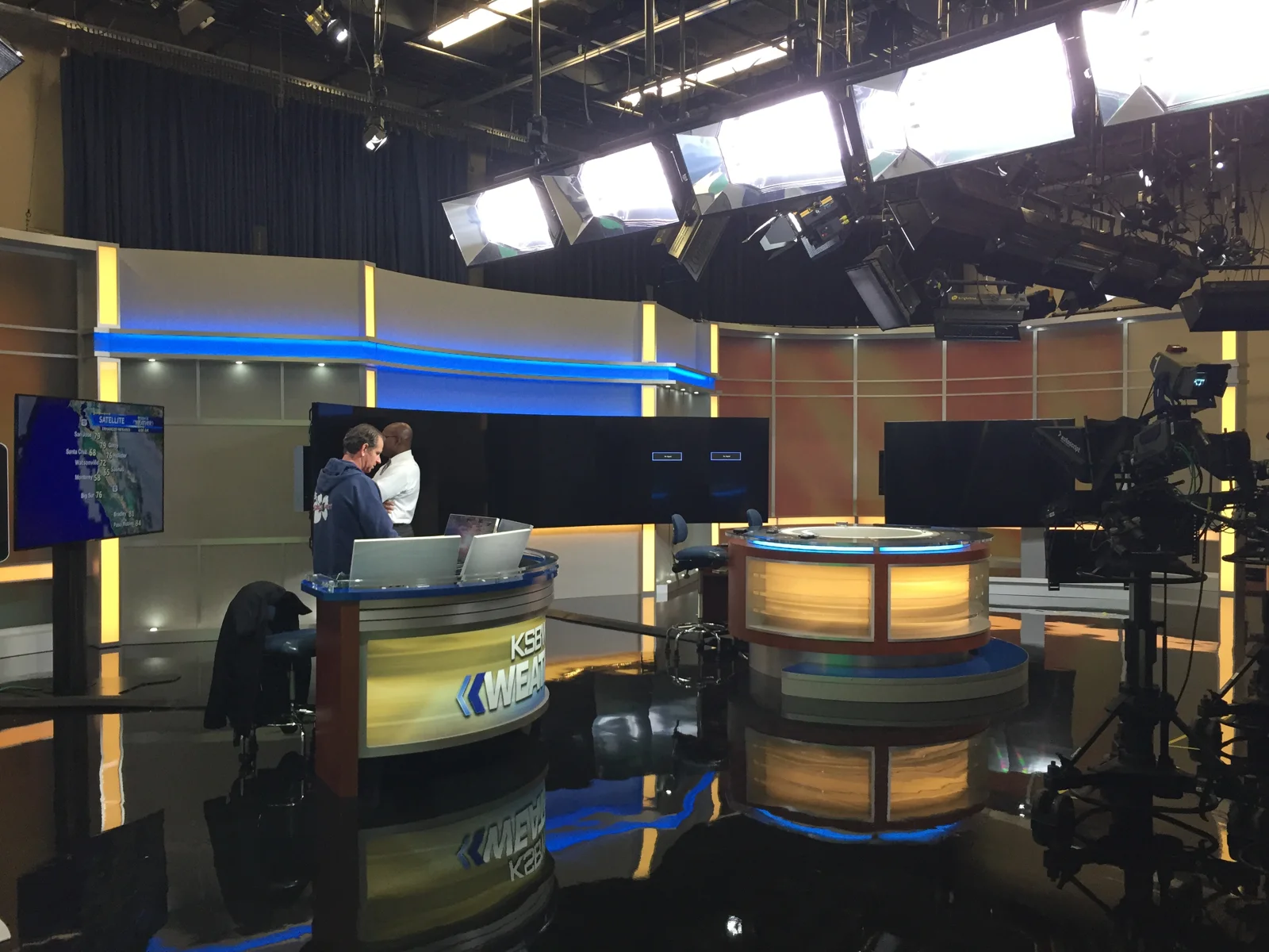 Studio cameras and presentation areas above the reflective finished floor