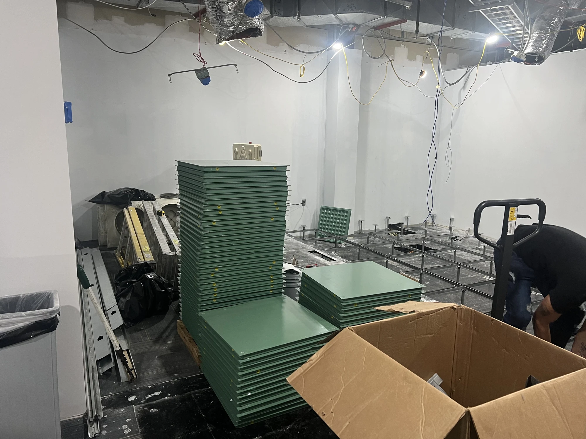 Floor panels staged beside the exposed supports